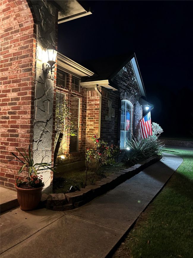 Property exterior at night featuring brick siding | Image 24