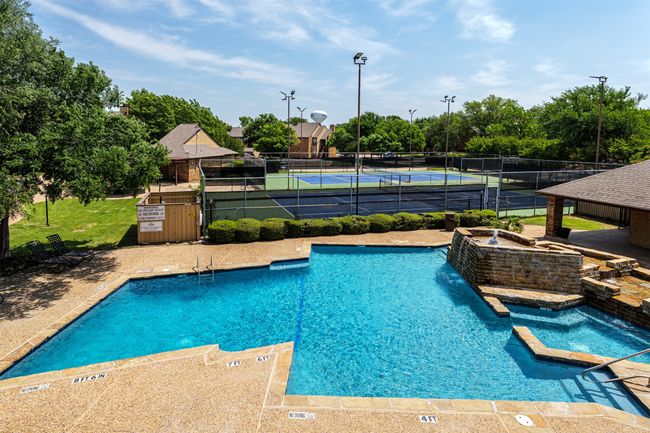 Community pool with fence, a hot tub, and a tennis court | Image 17