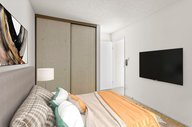 Bedroom featuring a closet, a textured ceiling, and wood finished floors | Image 26