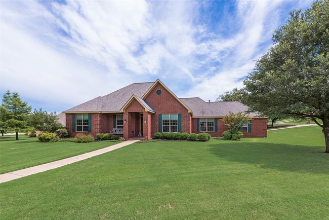 Ranch-style home with brick siding and a front lawn | Image 4