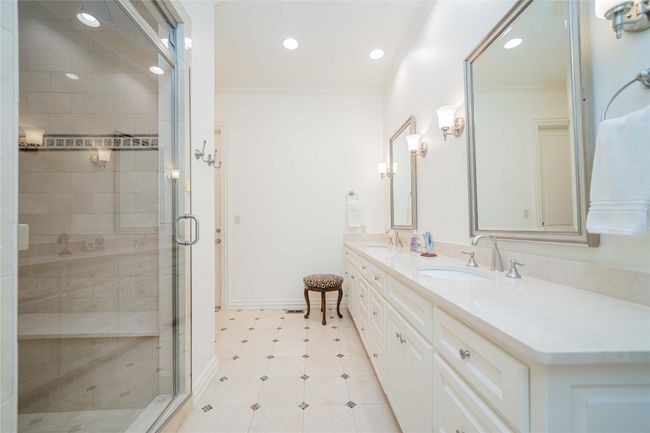 Bathroom featuring double vanity, a shower stall, ornamental molding, recessed lighting, and tile patterned flooring | Image 22