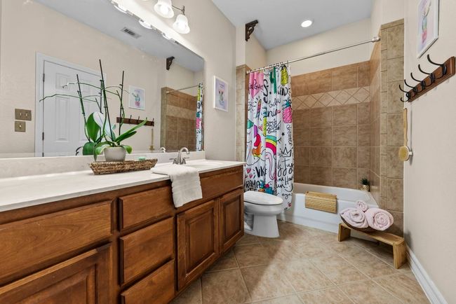 Secondary bath has an expansive counter top and an abundance of storage space | Image 22