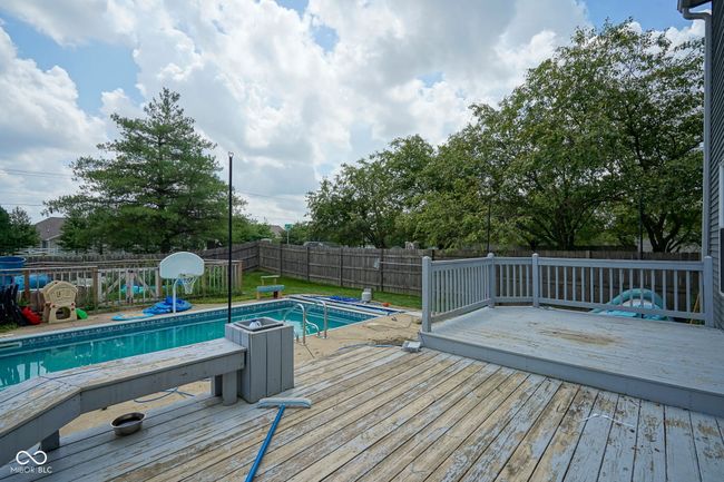 view of swimming pool with a fenced backyard and a wooden deck | Image 39