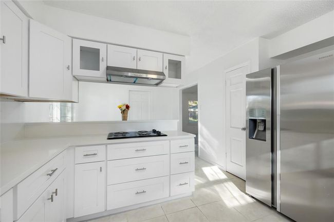 New cabinets, and over head blower. Fridge says with sale. | Image 18