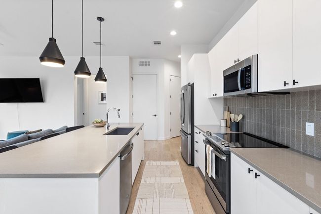 Spacious kitchen with tons of storage, kitchen island that you can eat at, and great light! | Image 30