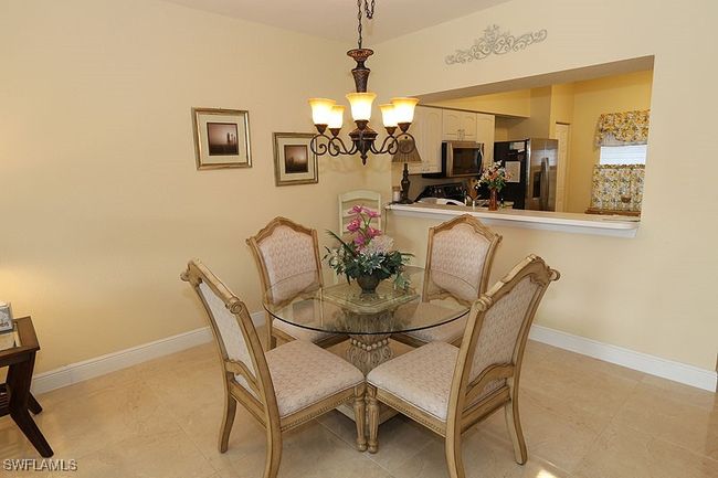 Tiled dining space with an inviting chandelier | Image 6
