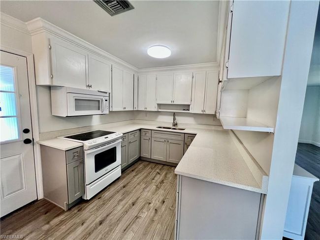 Kitchen with QUARTZ tops and newer cabinets. | Image 9