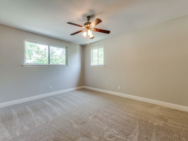 Carpeted empty room featuring baseboards and ceiling fan | Image 20