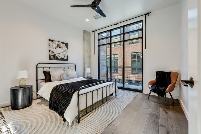 The primary bedroom feels expansive, with generous natural light pouring in through the large window, making the room feel both open and inviting | Image 19