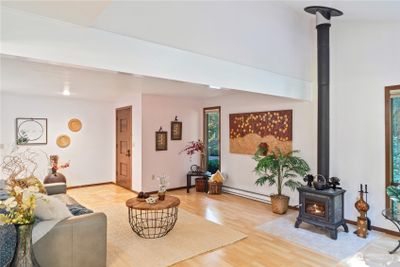 Spacious entryway opens into great room. Woodburning fireplace adds coziness and ambiance! | Image 3