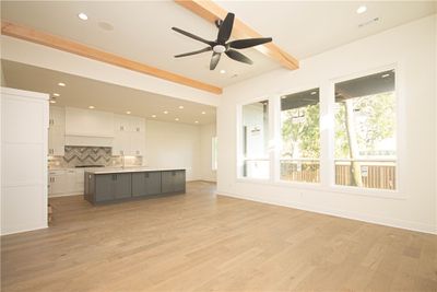 The living room is a stunning focal point of the home, featuring a custom tile fireplace that adds warmth and charm. | Image 3