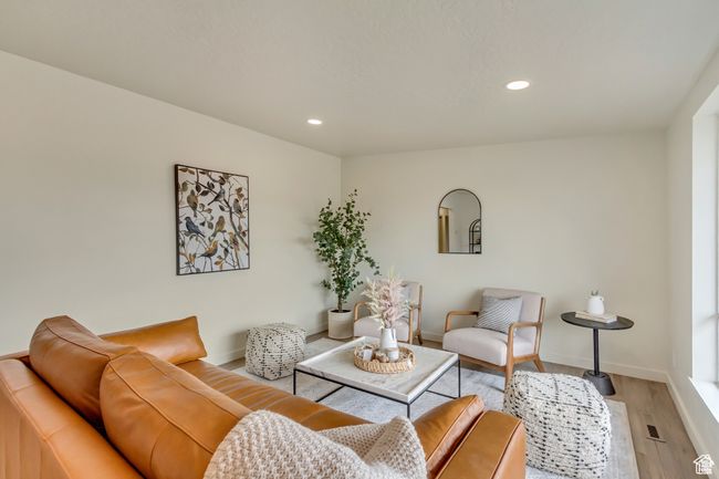 Living area featuring light wood finished floors, baseboards, and recessed lighting | Image 4