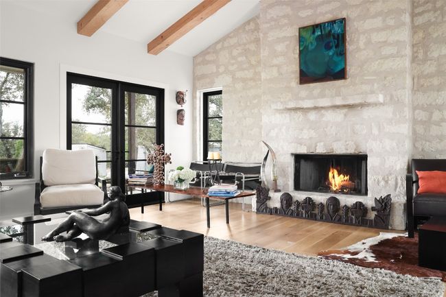 Living room featuring high vaulted ceiling, beam ceiling, a large fireplace | Image 16