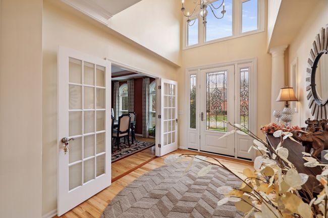 Bright and light entry foyer with French doors leading to the formal dining room. | Image 4