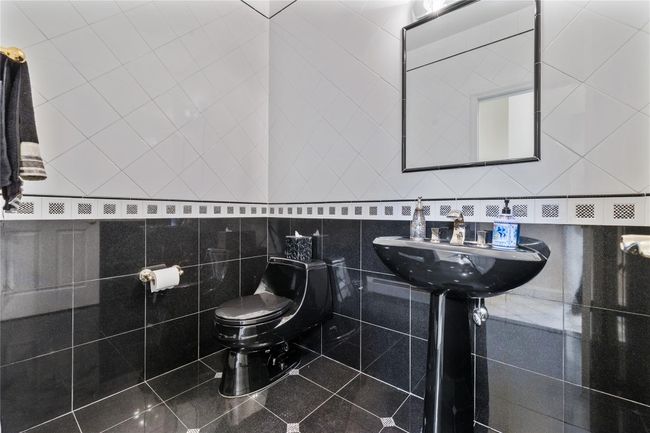 Bathroom featuring toilet and a sink | Image 19