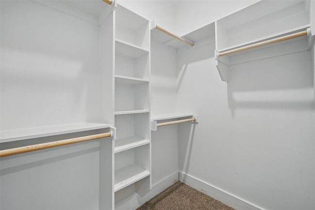 Walk in closet featuring carpet | Image 19