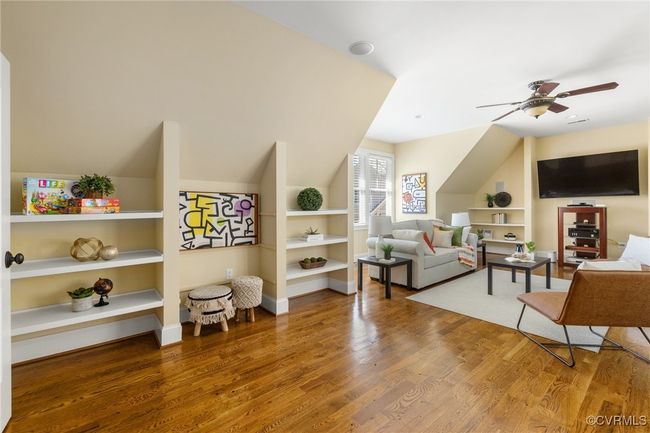 Site finished hard wood floors, surround sound, recessed lighting, ceiling fan with light, built in shelving. | Image 28