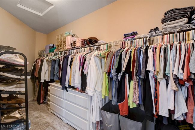 Walk in closet with lofted ceiling, attic access, and carpet | Image 41