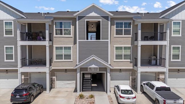 View of property with board and batten siding, an attached garage, and driveway | Image 27