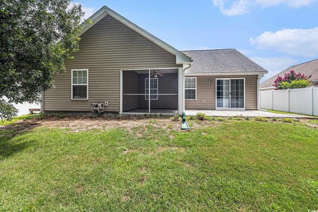 Rear view of property featuring a patio area, a ceiling fan, and a shingled roof | Image 35