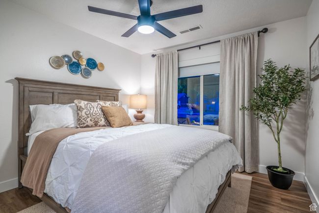 Bedroom with ceiling fan and dark hardwood / wood-style floors | Image 9