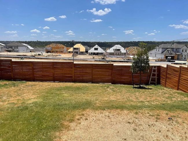 Fenced backyard with a residential view | Image 16