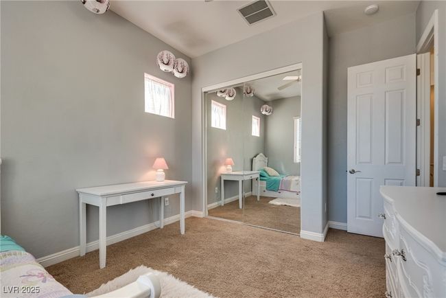 Bedroom with light colored carpet, visible vents, a closet, and baseboards | Image 40