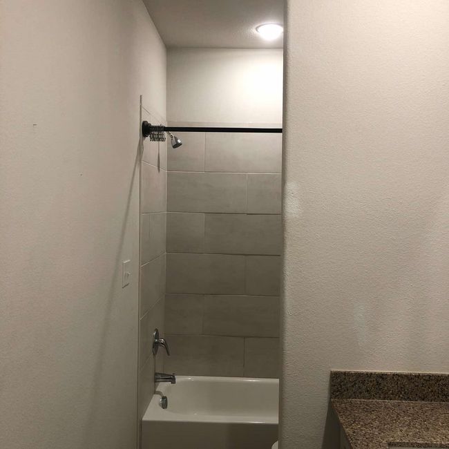Bathroom featuring bathing tub / shower combination and vanity | Image 17