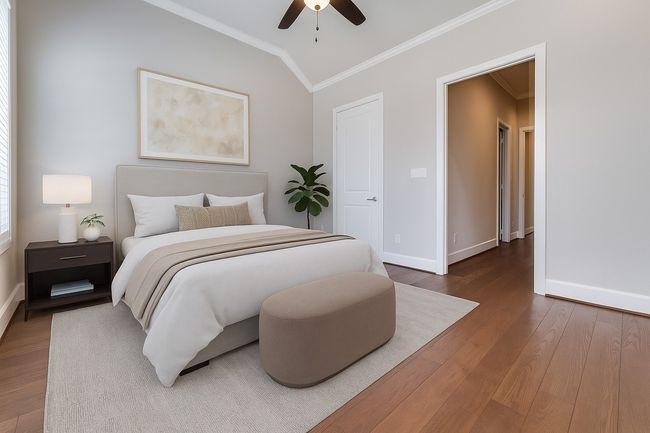 Bedroom with ornamental molding, wood finished floors, lofted ceiling, and ceiling fan | Image 10