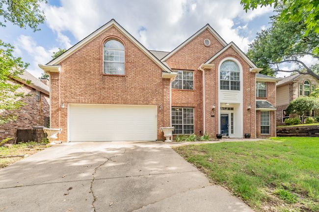 Two car garage with a single door and additional parking space for guests. | Image 37