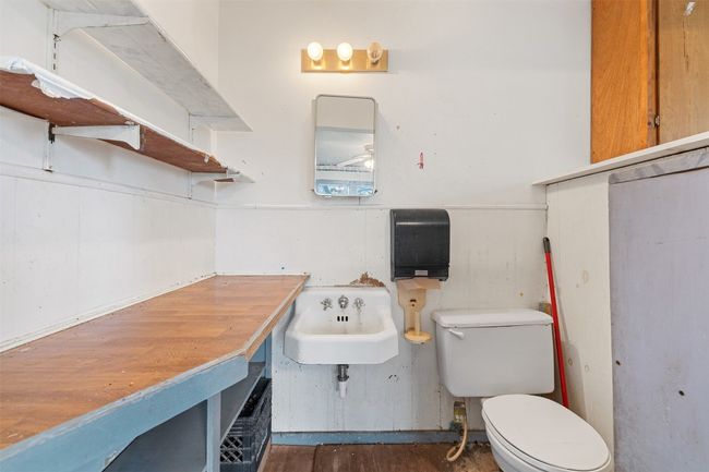 Half bath featuring wood finished floors, toilet, and a sink | Image 21