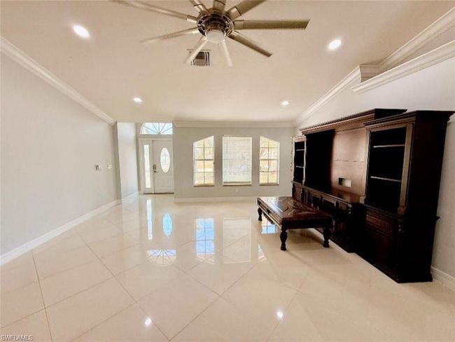 Living area with visible vents, ornamental molding, a ceiling fan, and light tile patterned floors | Image 7
