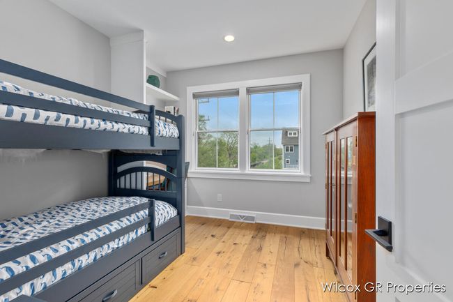 Bedroom #2 is perfect as an office and guest suite with hardwood floors, loads of natural light and 9' ceilings. | Image 28