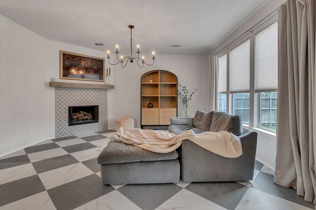 Living room featuring a chandelier and a tiled fireplace | Image 8