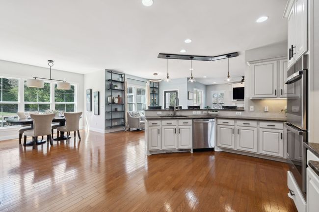 Spacious layout flows seamlessly into a sunlit dining space and cozy seating area. | Image 9