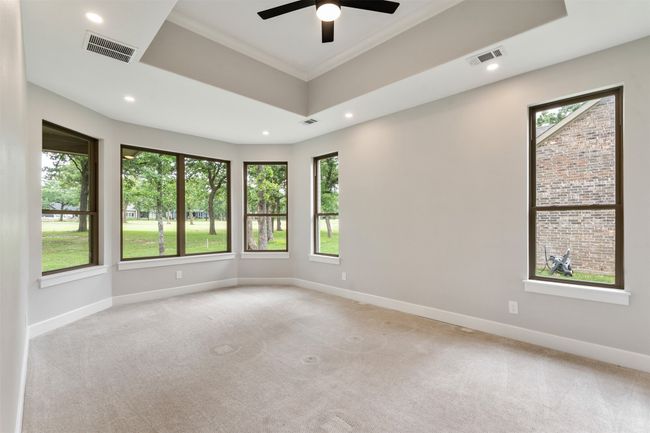 Primary bedroom with bay windows and views of the 17th fairway | Image 14