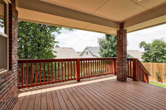Large covered deck with stairs into the yard. | Image 30