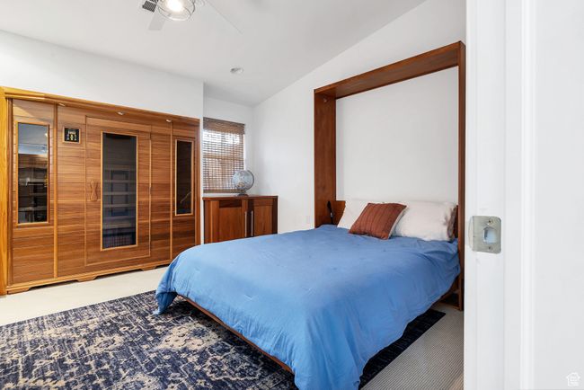 Carpeted bedroom featuring ceiling fan and lofted ceiling | Image 28