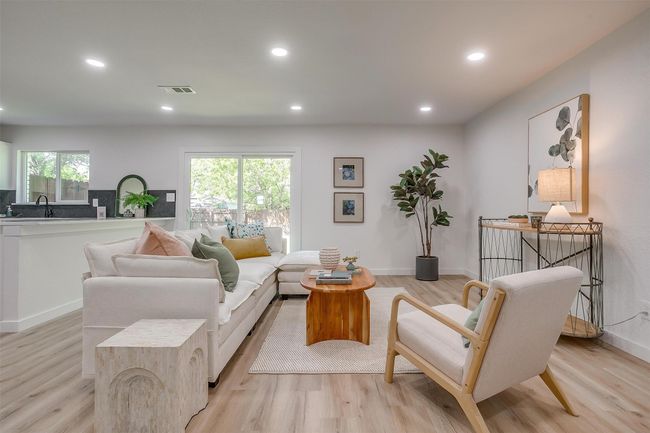 Living area with recessed lighting and light wood-style flooring | Image 4