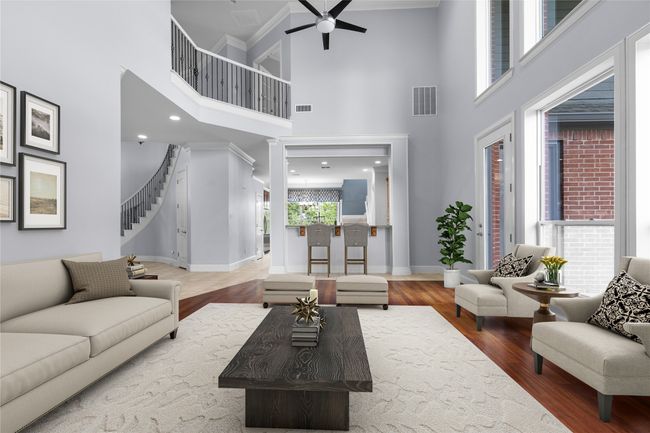Rich wood flooring, and oversized double windows that fill the space with natural light. | Image 6