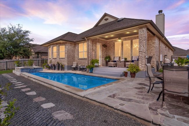 View of swimming pool with a patio and a pool with connected hot tub | Image 28