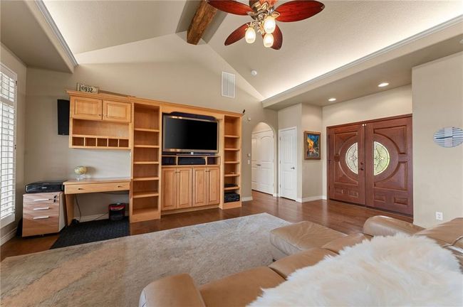 Living area with arched walkways, visible vents, a ceiling fan, and dark wood finished floors | Image 13