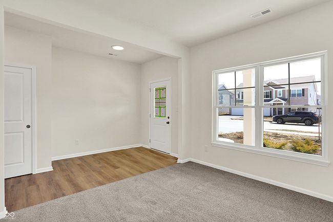 carpeted spare room featuring visible vents, a healthy amount of sunlight, and baseboards | Image 4