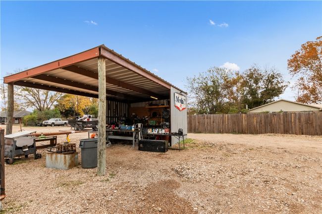View of parking / parking lot with a utility shed | Image 27