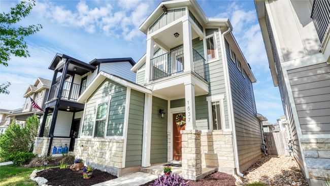 View of front facade featuring stone siding, a balcony, and fence | Image 24