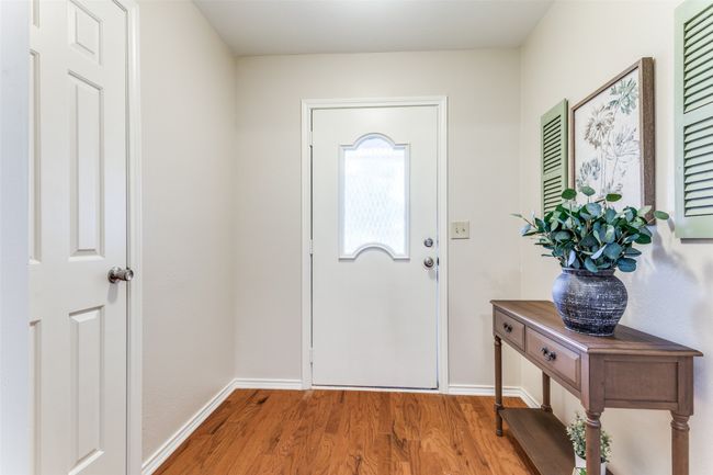 Entrance foyer featuring baseboards and wood finished floors | Image 5