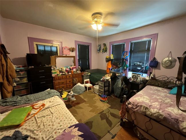Bedroom featuring a ceiling fan | Image 11