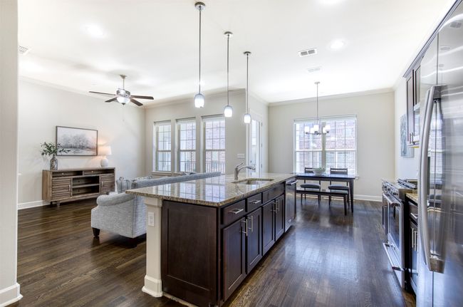 Kitchen with large eat-in island with pendant lighting. | Image 13