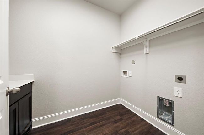 Laundry room located on the first floor features a counter top and cabinets that are a great addition to the laundry area. | Image 29