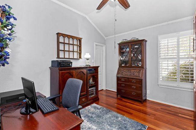 Bedroom/Office space featuring ceiling fan, ornamental molding, a healthy amount of sunlight, and dark hardwood / wood-style flooring | Image 21